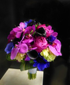 Sumptuous Jewel-toned bridal bouquet featuring phalaenopsis orchids, anemone, peonies, and callas.